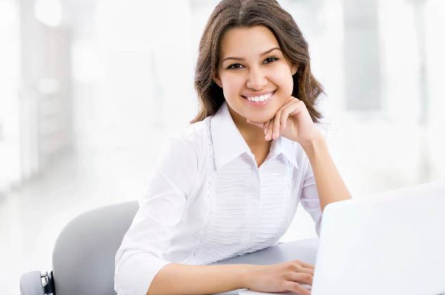 Business woman working on laptop computer at office